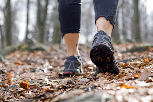 Woman walking in autumn forest