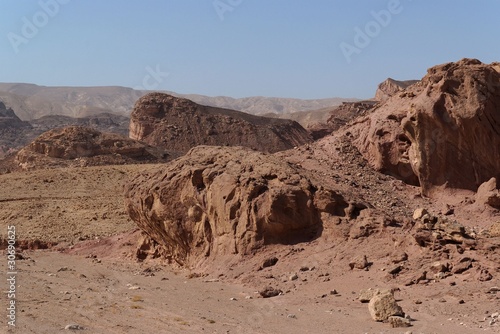 Scenic weathered red rocks  in stone desert photo