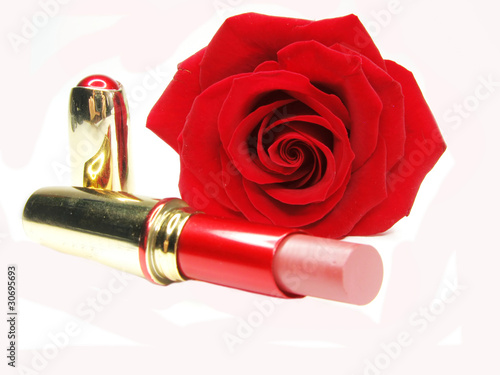 red lipstick with rose on background