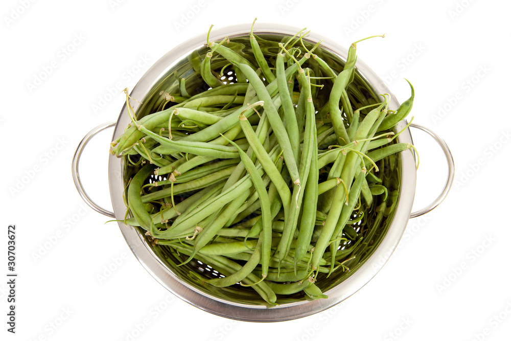 colander with long green beans over white background colander with long green beans over white background