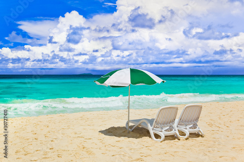 Chairs and umbrella at tropical beach © Nikolai Sorokin
