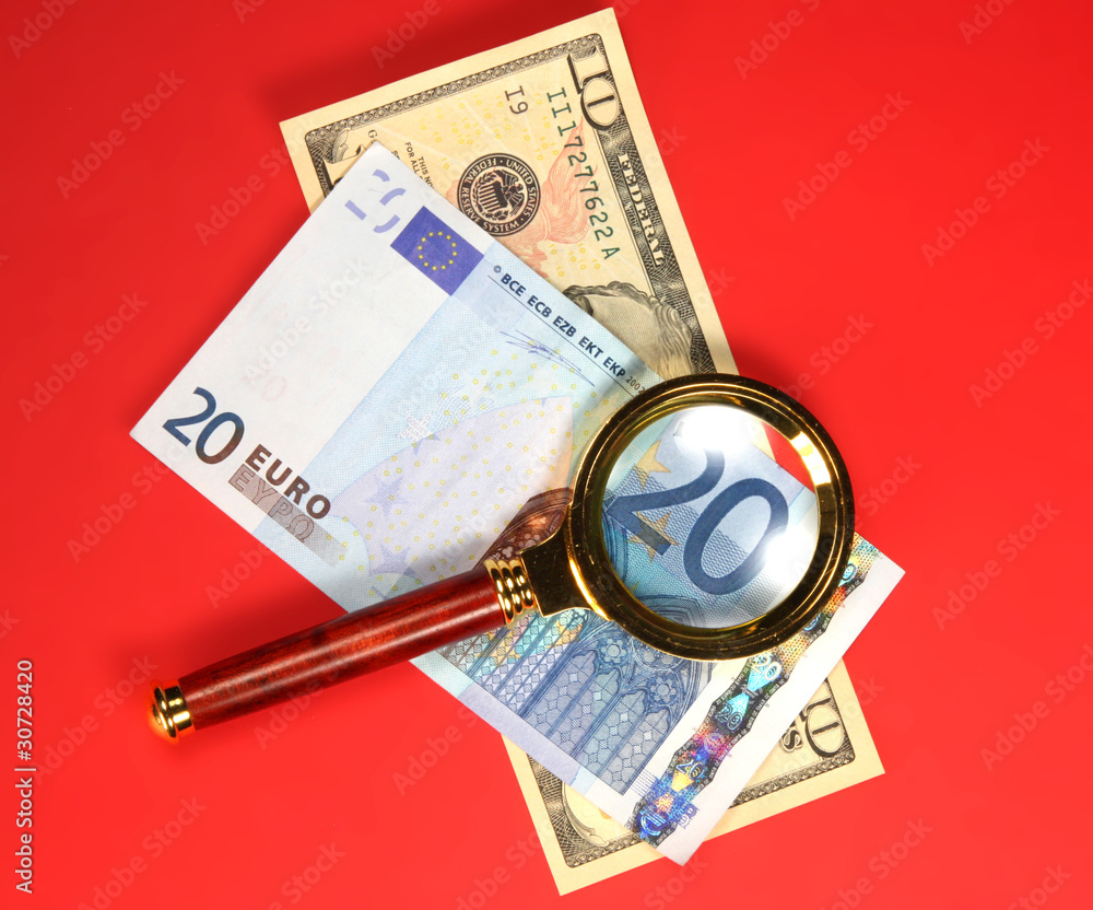 Detail of Twenty euro Bill Through a Magnifying Glass on red Detail of Twenty euro Bill Through a Magnifying Glass on red