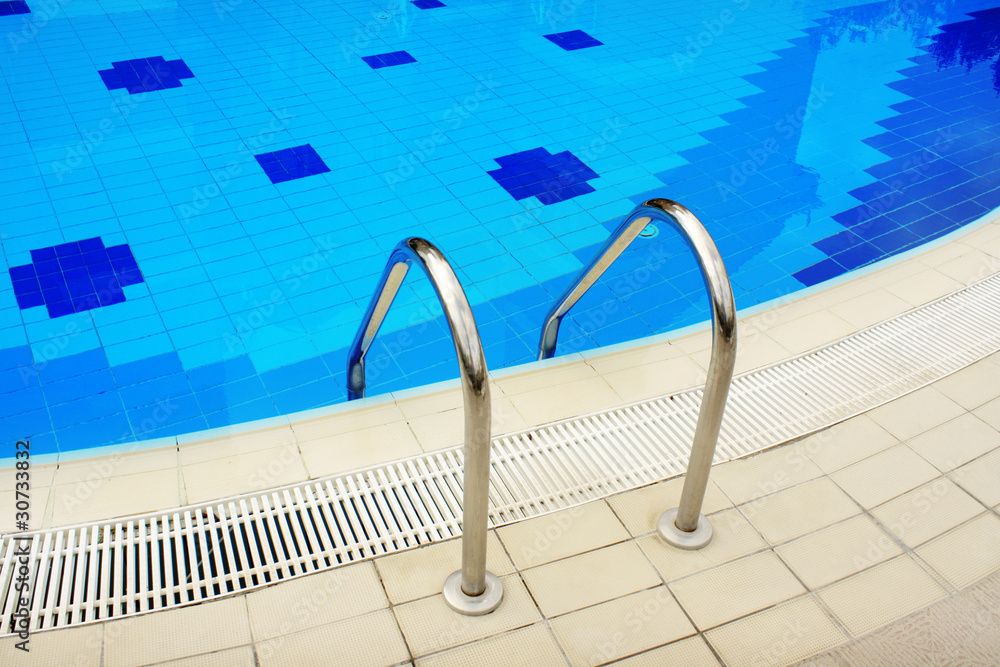 Swimming pool with stair at hotel close up