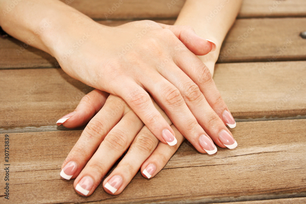 Woman hands with french manicure Woman hands with french manicure