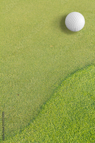 Golf ball on green tee