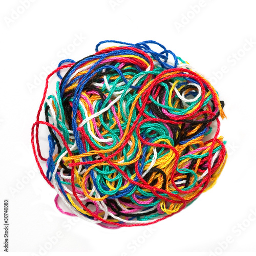 ball of multicolored woolen threads on white