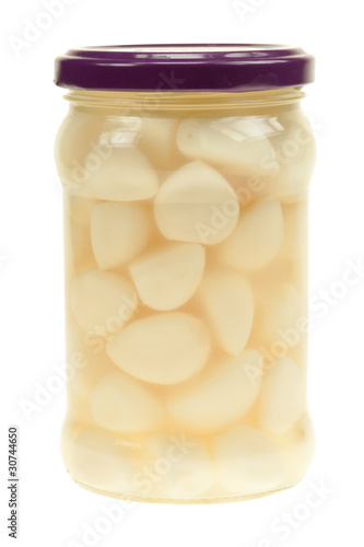 A jar of garlic pieces isolated