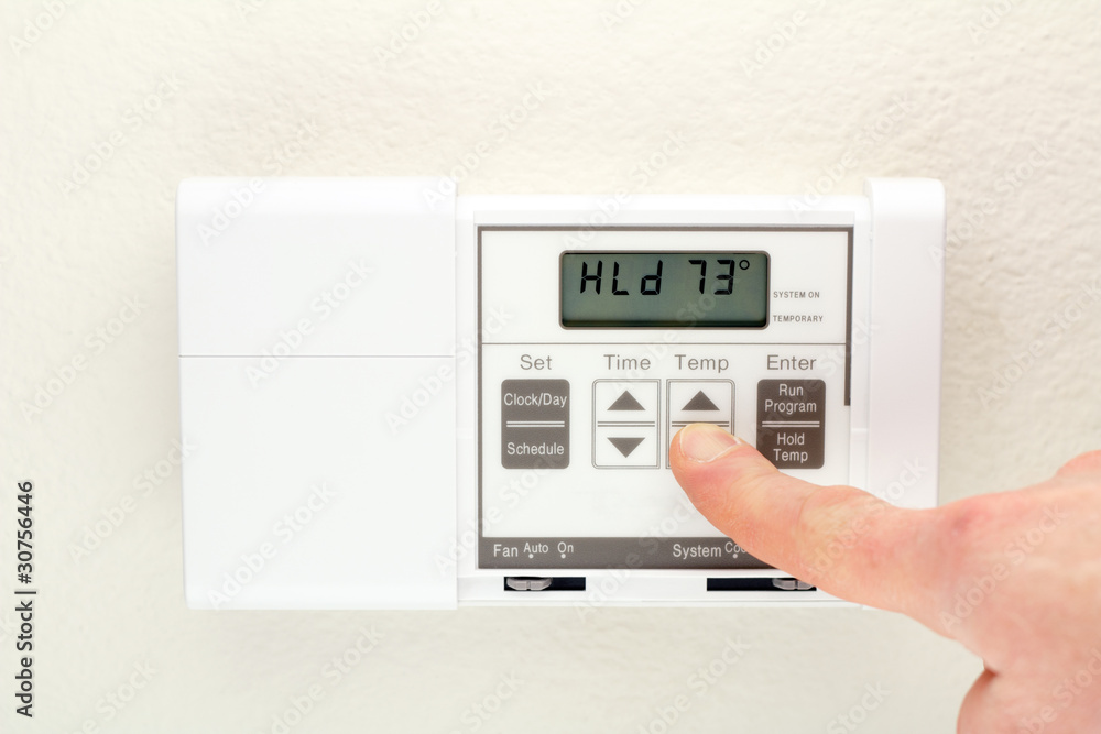 Hand on Thermostat Hand on Thermostat