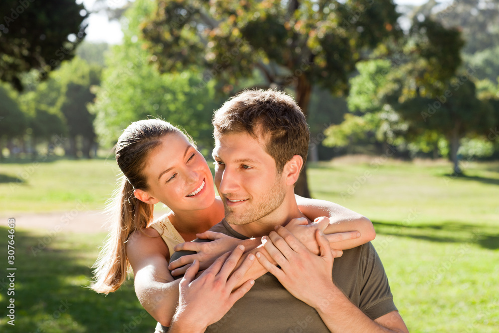 Fototapeta premium Woman hugging her handsome husband