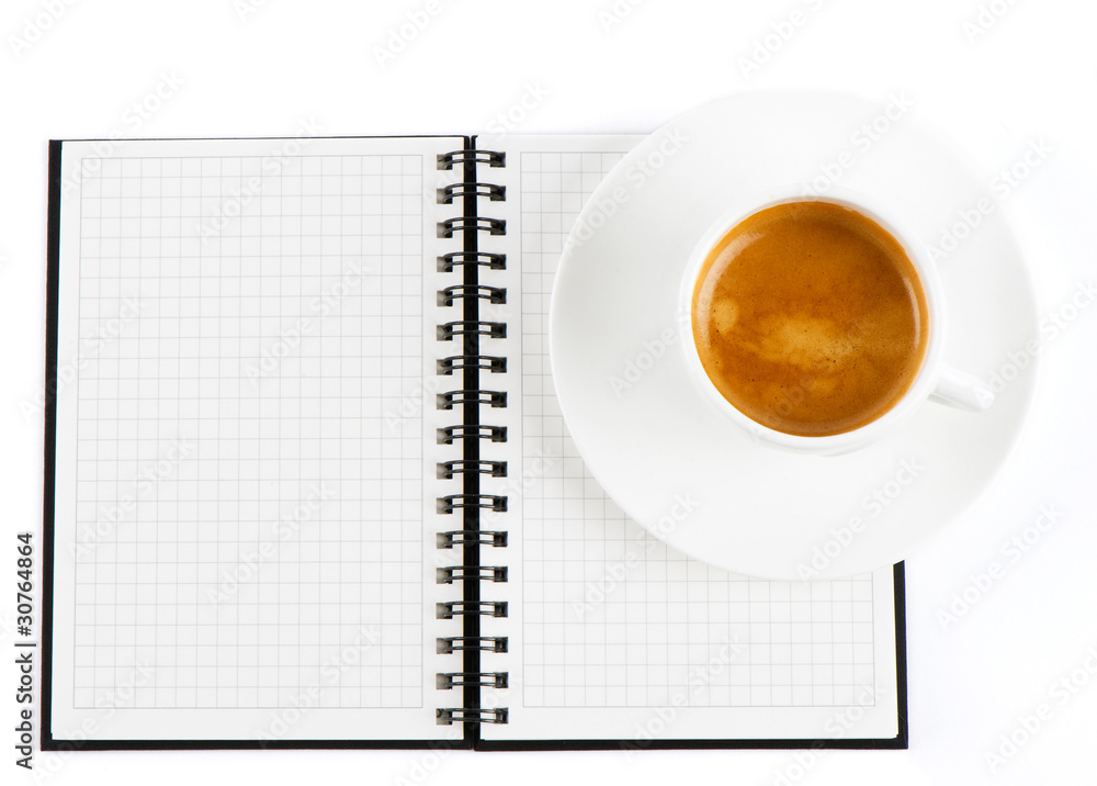 Cup of hot coffee and open note book Cup of hot coffee and open note book