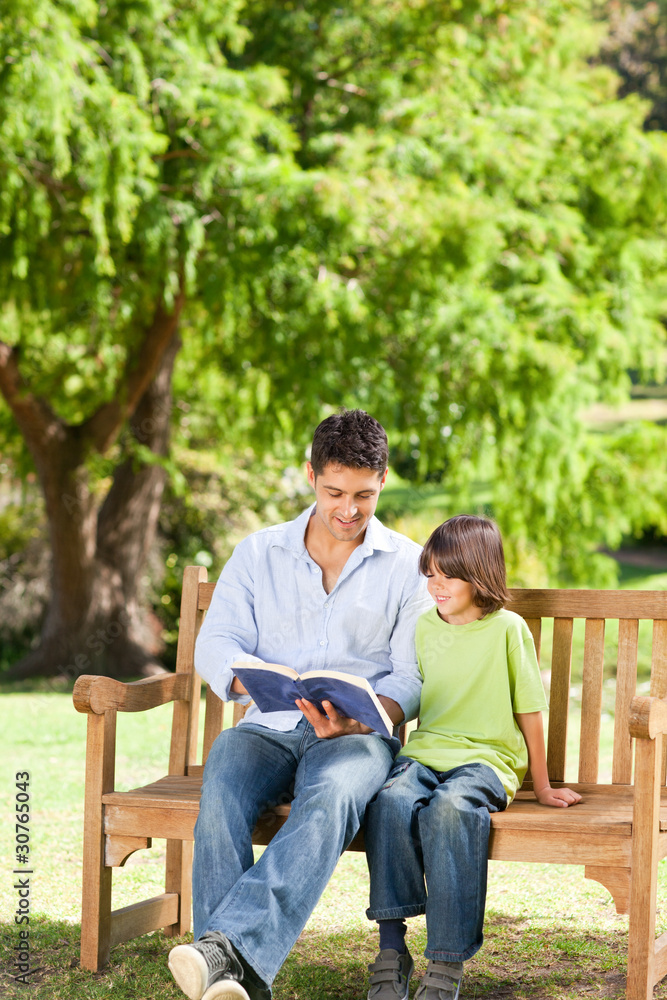 Father with his son reading a book Father with his son reading a book