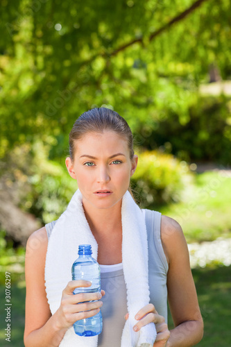 Woman drinking water after the gym