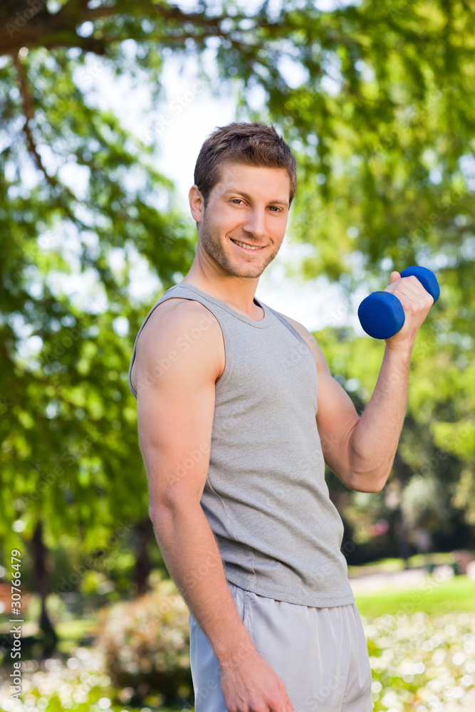 Young man doing his exercises in the park Young man doing his exercises in the park
