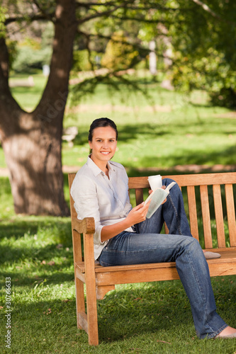 Young woman reading on the bench