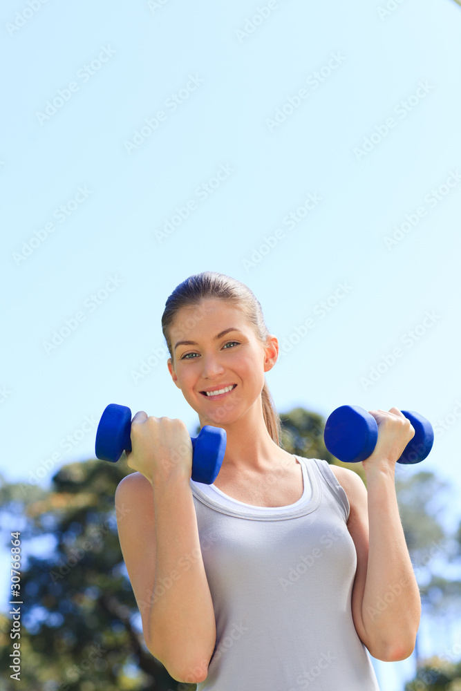 Young woman doing her exercises in the park Young woman doing her exercises in the park
