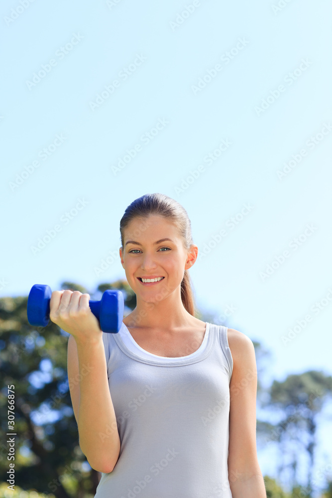 Young woman doing her exercises in the park Young woman doing her exercises in the park