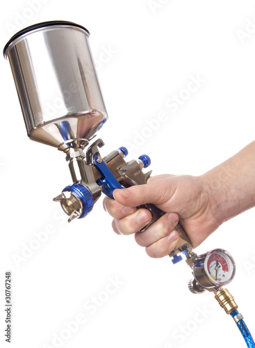 Hand and spray gun at work