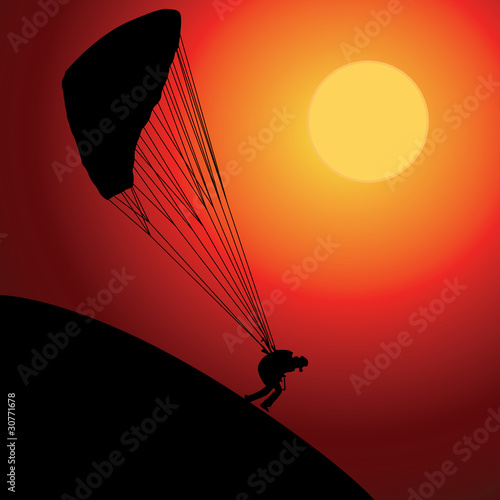Paraglider over sunset