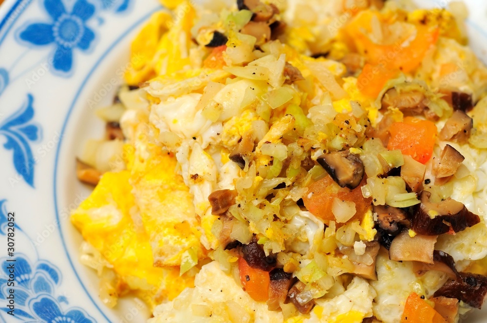 Freshly cooked egg with vegetable topping Freshly cooked egg with vegetable topping