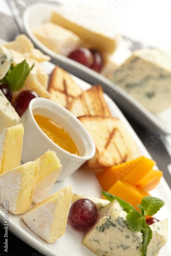 Cheese plate with grapes and honey