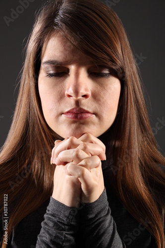 Wallpaper Mural Religious woman eyes closed hands clasped praying Torontodigital.ca