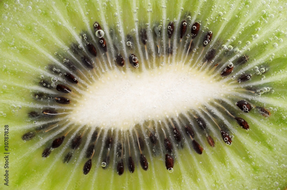 Detail shot of a green kiwi with bubbles Detail shot of a green kiwi with bubbles