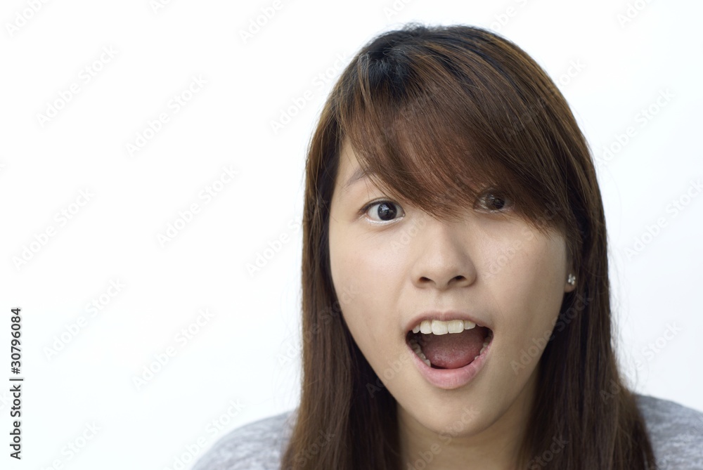 Young chinese lady with surprised look on white Young chinese lady with surprised look on white