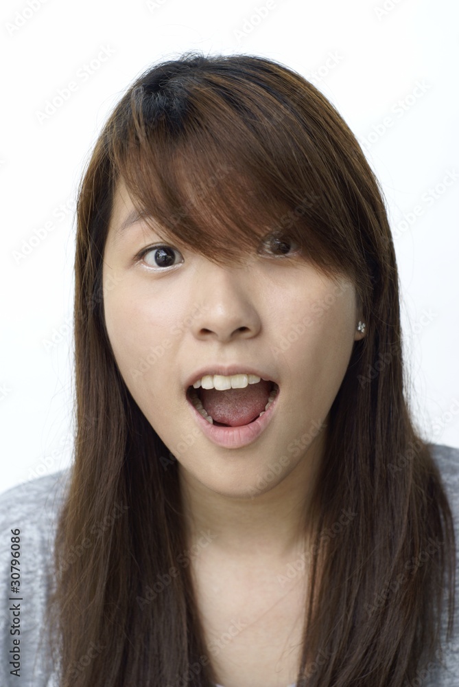 Young chinese lady with surprised look on white Young chinese lady with surprised look on white