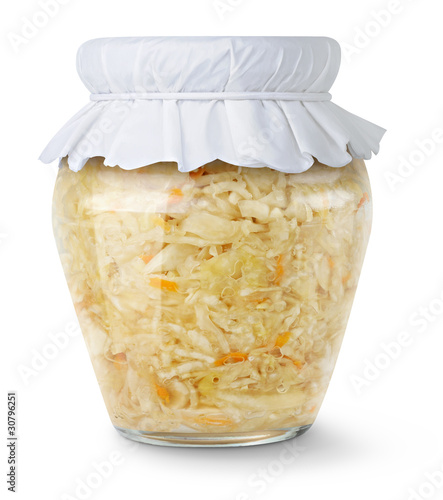 Isolated sauerkraut. Marinated cabbage (sauerkraut) in glass jar with paper lid isolated on white background photo