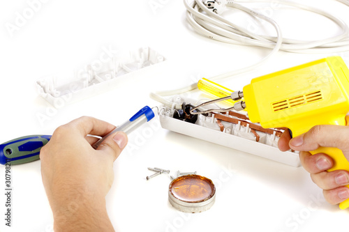Hands repairing extension cord photo