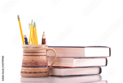 Cup of Pens and Pencils with College Textbooks