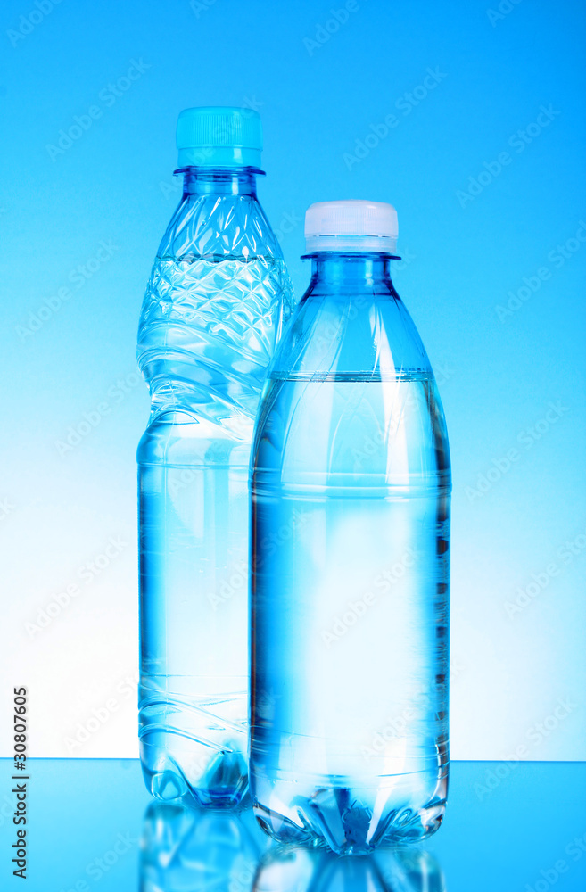 Bottles of water on blue background Bottles of water on blue background