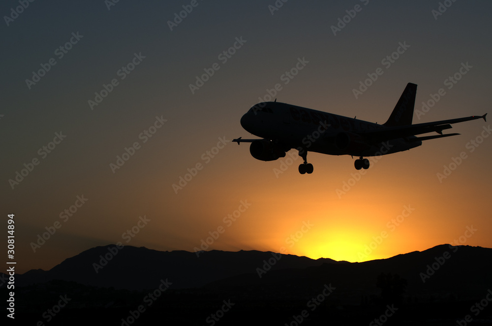 Aircraft landing in sunset Aircraft landing in sunset