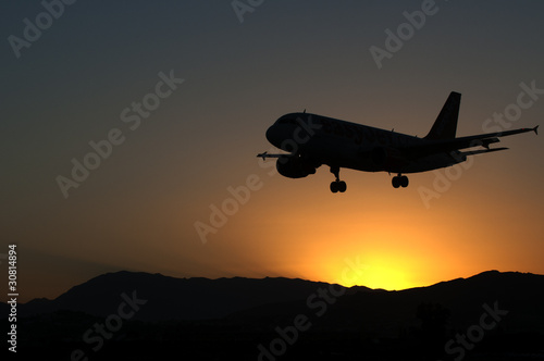 Aircraft landing in sunset