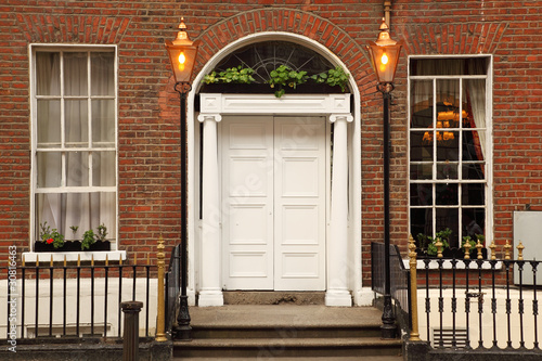 first floor and entrance to beautiful building, white door photo