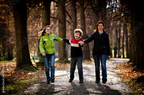 Active family - mother and kids walking outdoor