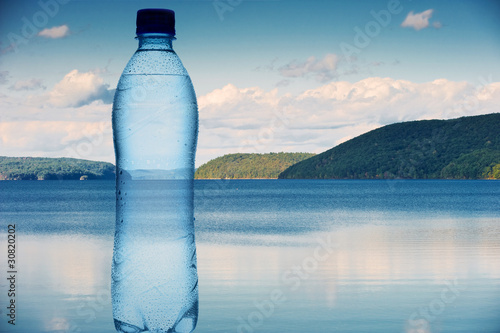 Bottle of water against the nature background