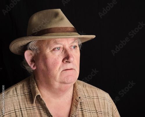 portrait of senior male wearing a hat
