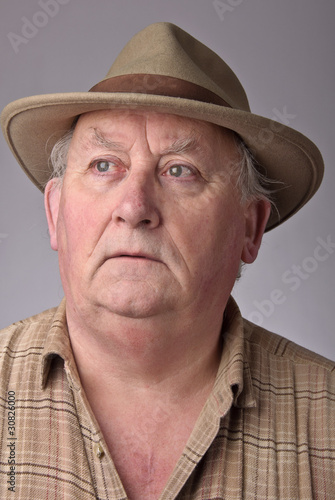 portrait of senior male wearing a hat