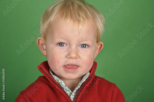 portrait of a little boy on a green screen