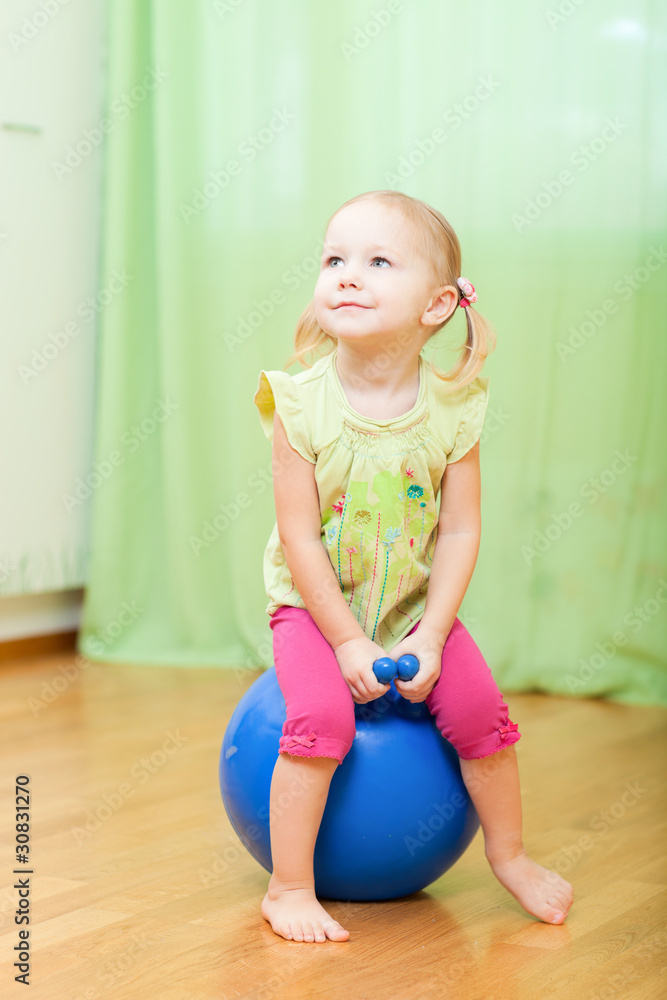 Toddler girl jumping on ball Toddler girl jumping on ball