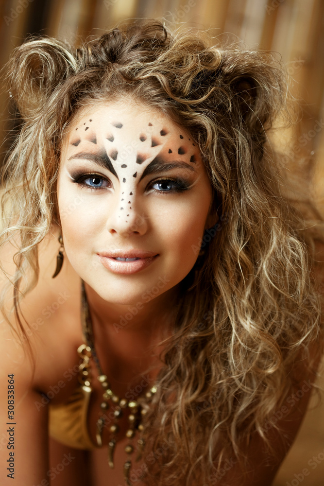 Fototapeta premium Girl with an unusual make-up as a leopard