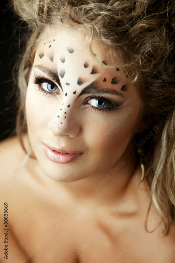 Girl with an unusual make-up as a leopard