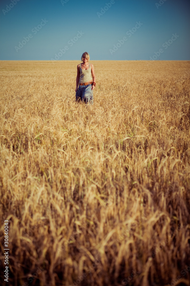 Image of young woman on wheat field