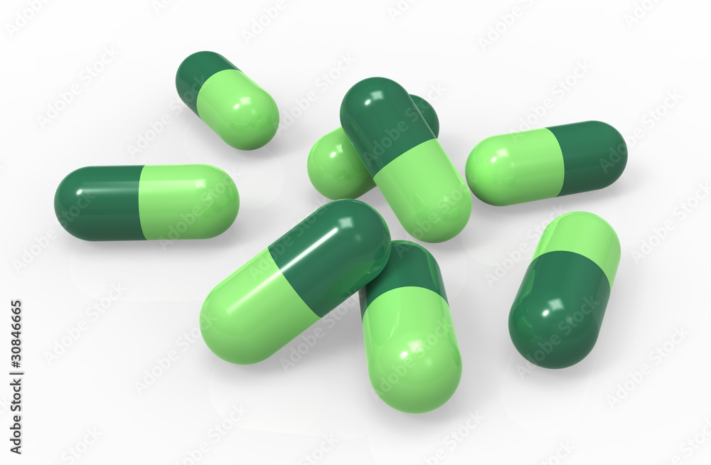 Green medical capsules isolated on white background, close-up Green medical capsules isolated on white background, close-up