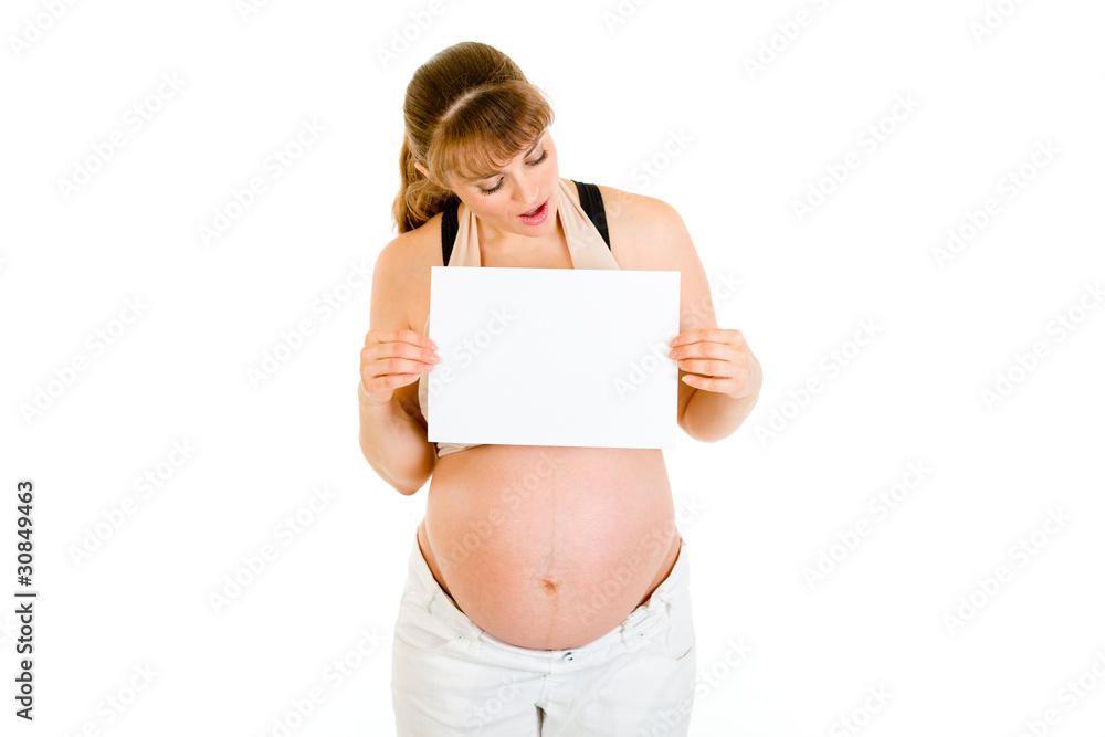 Surprised pregnant woman looking on white paper Surprised pregnant woman looking on white paper