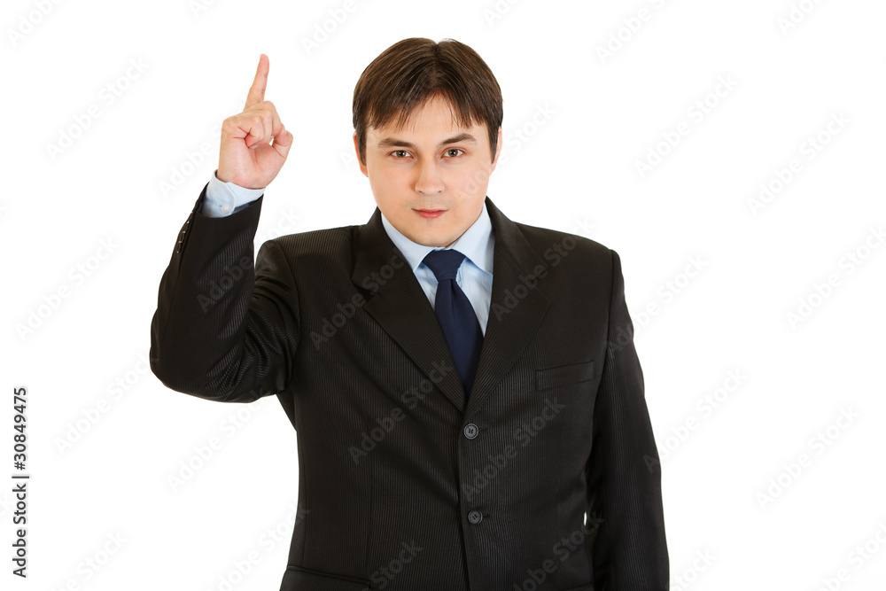 Interested modern businessman pointing finger up Interested modern businessman pointing finger up