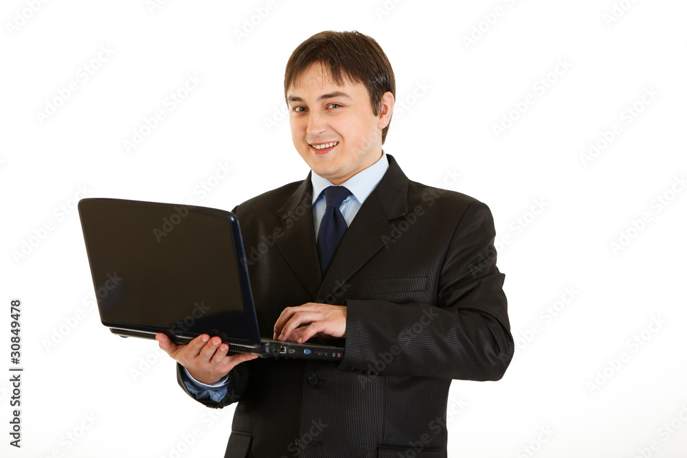 Smiling modern businessman using laptop isolated on white. Smiling modern businessman using laptop isolated on white.