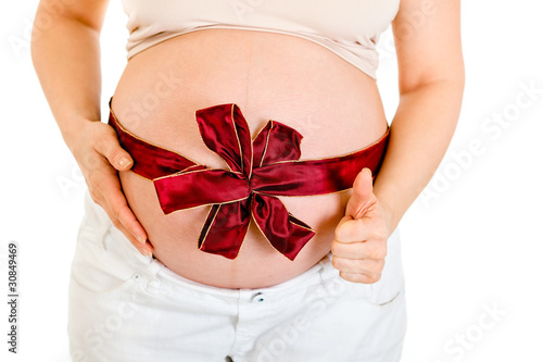Wallpaper Mural Pregnant woman with ribbon on belly showing thumb up. Close-up. Torontodigital.ca