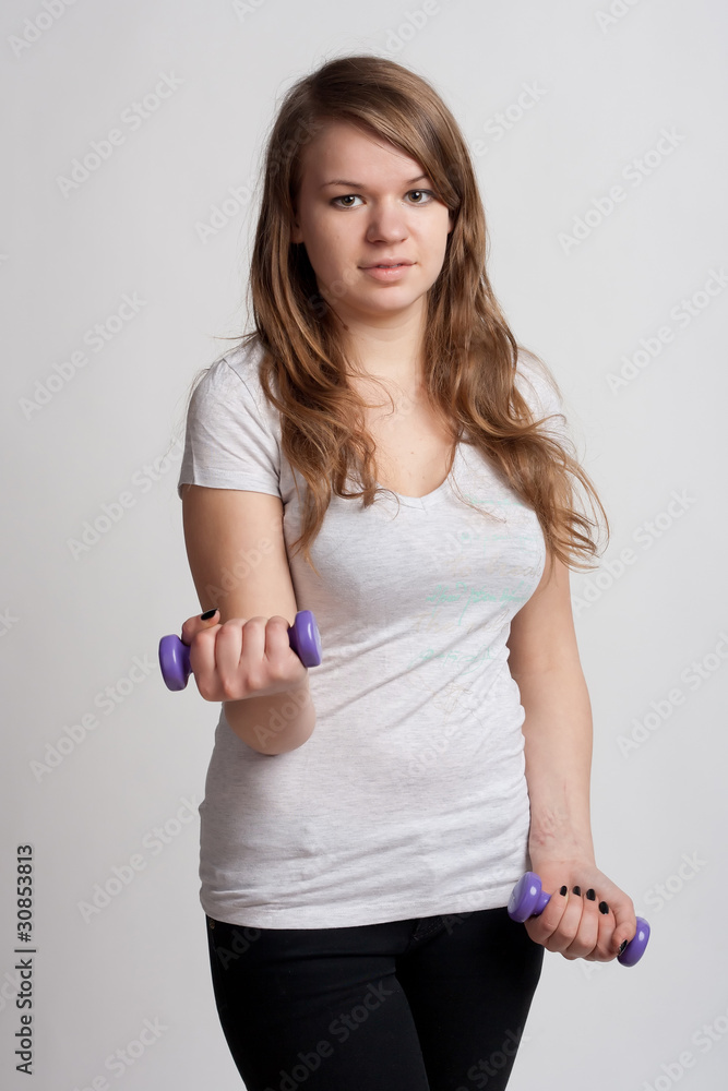 Naklejka premium girl with dumbbells in hand